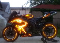 a black motorcycle parked on top of a sidewalk