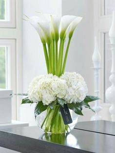 a glass vase with white flowers in it