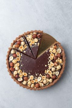 a chocolate and hazel nut tart with text overlay reading amazing no - bake chocolate & hazelnut tart