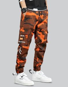 Orange Techwear Pants Cotton Techwear Cargo Pants For Sports, Techwear Cotton Joggers For Streetwear, Camouflage Cotton Cargo Pants In Techwear Style, Hip Hop Winter Pants For Outdoor, Hip Hop Style Winter Pants For Outdoor, Stretch Cargo Pants For Winter Streetwear, Stretch Winter Cargo Pants For Streetwear, Cotton Techwear Sweatpants For Outdoor, Stretch Cotton Techwear Parachute Pants