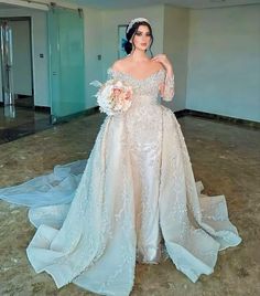 a woman in a wedding dress posing for the camera