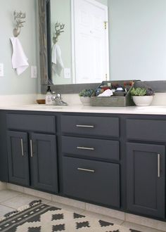 a bathroom vanity with two sinks and a large mirror