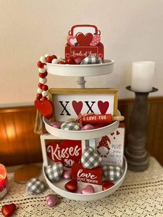 three tiered trays holding valentine's day cards and other items on a table