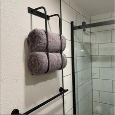 two towels are hanging on a towel rack next to a shower