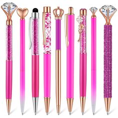 pink and gold pens with diamonds on the top, in different shapes and sizes are lined up next to each other