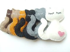 several different types of hair clips on a white surface with eye lashes and cat's eyes