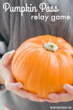 a person holding a pumpkin in their hands with the words, pumpkin pass relay game