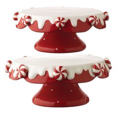 two red and white cake stands with candy canes on them