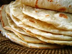 a stack of tortillas sitting on top of a table