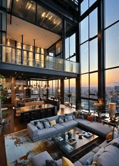 a living room filled with lots of furniture and tall windows overlooking the city at sunset