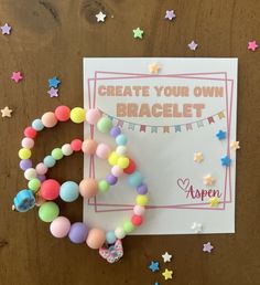 a card with some beads on it next to a bunch of stars and confetti