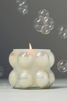 a candle with bubbles floating around it