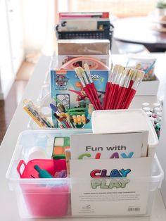 the table is full of arts and crafts supplies for kids to use in their homes