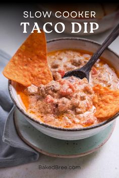 slow cooker taco dip in a bowl with tortilla chips