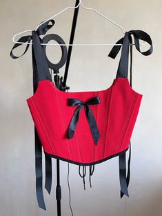 Red corset top with black elements❤️🖤  *The straps are cut with a stitch and tied with bows🎀  *There is a black satin bow in the centre *There is a seam along the lines, an ornament in the form of leaves  *the corset has a cotton lining the corset is made in one copy ✅ Fits this size: for bust 33.1-35.8 inch (84-91cm)  waist 24.8-26.8 inch (63-68 cm) Elegant Red Corset Belt For Party, Party Underbust Corset Belt, Black Corset With Straps For Costume Party, Party Underbust Corset Belt With Straps, Gothic Corset Belt With Straps For Party, Red Sleeveless Boned Bodice Corset, Elegant Red Underbust Corset, Summer Red Corset With Straps, Overbust Corset With Straps For Costume Party