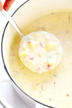 a spoon in a pot filled with soup