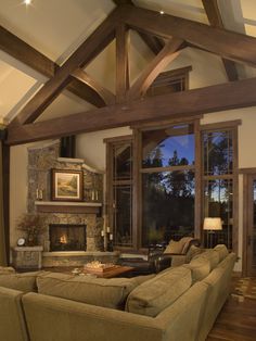 a living room filled with furniture and a fire place in the middle of a room