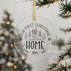 a glass ornament hanging from a christmas tree with the words our first christmas is in new home