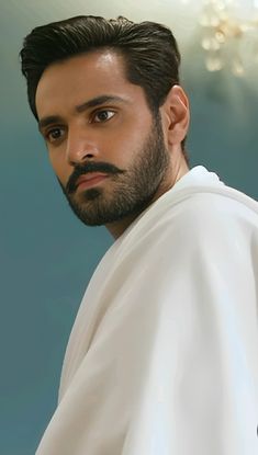 a man with a beard wearing a white shirt