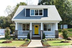 a blue and white house with a yellow door