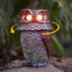 an owl with glowing eyes is sitting on a rock and has its head turned towards the camera