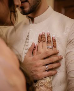 a man and woman holding each other with their hands