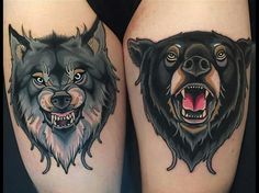 two black and grey wolf tattoos on both thighs, one with an open mouth