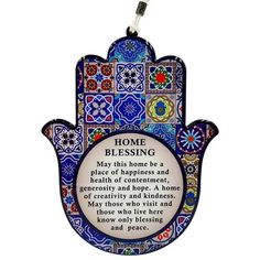 a hamsa hanging from a string with a poem on it that says, home blessing