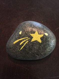 a rock with a yellow star painted on it