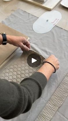 a person is working on an object in the process of making something out of cardboard