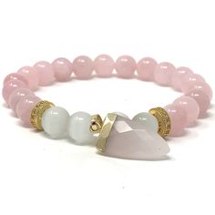 Precious looking white Cat's eye & rose quartz bracelets with a gold plated rose quartz pendant. The pink color and unique pattern of the cat's eye stone make these bracelets a wonderful everyday piece, wear it to polish up any look.Cat's Eye (Chrysoberyl) is said to make its wearer emotionally stable, fortify their spirit and protect from all types of negativity - physical, energetic and emotional. It also enhances intuition. Cat's Eye dispels unwanted energy from the aura. It amplifies good lu Pink Rose Quartz Bracelets For Meditation, Pink Rose Quartz Bracelet For Meditation, Rose Gold Rose Quartz Jewelry With 8mm Beads, Valentine's Day Pink Rose Quartz Bracelets, Pink Rose Quartz Bracelets For Valentine's Day, Elegant Rose Quartz Bracelets For Valentine's Day, Spiritual Rose Gold Rose Quartz Bracelet, Spiritual Rose Gold Rose Quartz Crystal Bracelet, Elegant Rose Quartz Bracelet For Valentine's Day