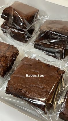 chocolate brownies wrapped in plastic sitting on top of a counter