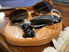 a pair of sunglasses sitting on top of a wooden table