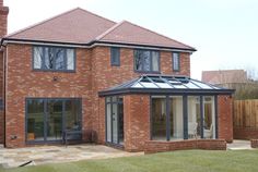 a large brick house with glass doors and windows