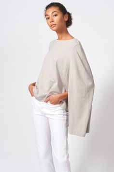 Our Cape Sweatshirt in our Bamboo and Cotton French Terry is the perfect combination of casual and chic. With enough attitude to turn heads, this style pairs well with your favorite jeans or slim trousers. Boatneck shape with facing, cape back detail with longer length, wide hem finish. - 67% Bamboo Rayon, 28% Cotton, 5% Elastin - Made in NYC - Dry Clean or Machine Wash - Our model is 5'9" wearing size S - Chest: 37", Bottom Width: 40, Length: 27 1/4" Orders are processed within three business d Chic Oversized Fall Tops, Modern Relaxed Fit Tops For Fall, Modern Everyday Fall Tops, Chic Batwing Sleeve Tops For Fall, Modern Everyday Tops For Fall, Modern Tops For Everyday Fall Wear, Versatile Batwing Sleeve Workwear Tops, Versatile Batwing Sleeve Tops For Workwear, Modern Relaxed Fit Blouse For Fall