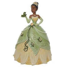 a figurine of a woman in a green dress with flowers on her hand