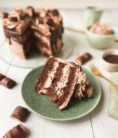 two pieces of chocolate cake sitting on top of a green plate