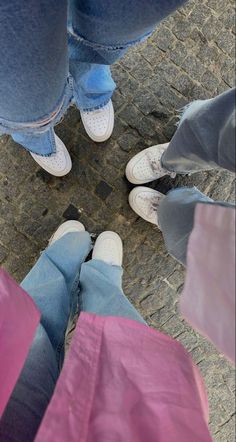 three people standing in the middle of a circle with their feet on each other's legs