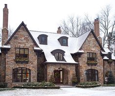 a large brick house with snow on the ground