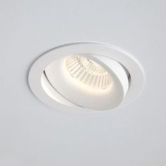 a white light that is on in the ceiling with a dim lighting fixture above it