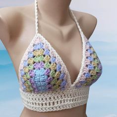 a crocheted halter top is displayed on a mannequin's head