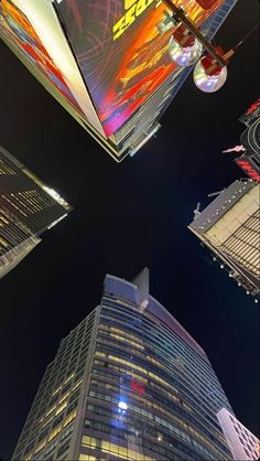 looking up at skyscrapers in the city at night