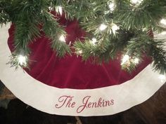 a christmas tree skirt with lights on it and the name'the genkins '