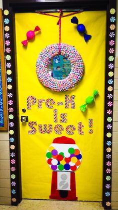 a door decorated with an image of a candy machine and the words pre - k is for