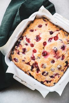 a close up of a cake in a pan on a table next to a napkin