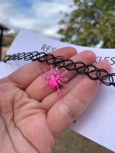 Each resin spider pendant is handmade to order, therefore no two chokers are identical! However, I try to get as close as possible :) Spider pendant is approximately 0.75" x 0.75" Pendant is made with epoxy resin and chunky holographic neon pink glitter✨ Colors may vary slightly. One size fits all black elastic tattoo choker necklace. Thanks for visiting my shop! 🕷💖 Adjustable Rave Choker For Gifts, Adjustable Rave Choker For Gift, Adjustable Rave Choker As Gift, Adjustable Harajuku Choker As Gift, Adjustable Harajuku Style Choker As Gift, Pink Punk Choker As A Gift, Rave Jewelry For Halloween Party, Pink Punk Choker For Gift, Pink Punk Choker As Gift