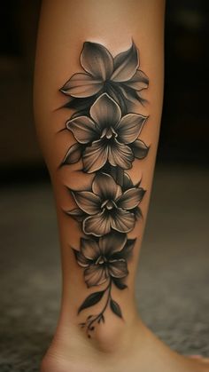 a black and white flower tattoo on the leg