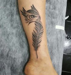 an owl with a feather tattoo on its foot