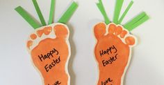 there are two carrots with happy easter written on them and green stems sticking out of the feet