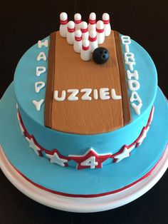 a birthday cake with bowling pins and balls on it